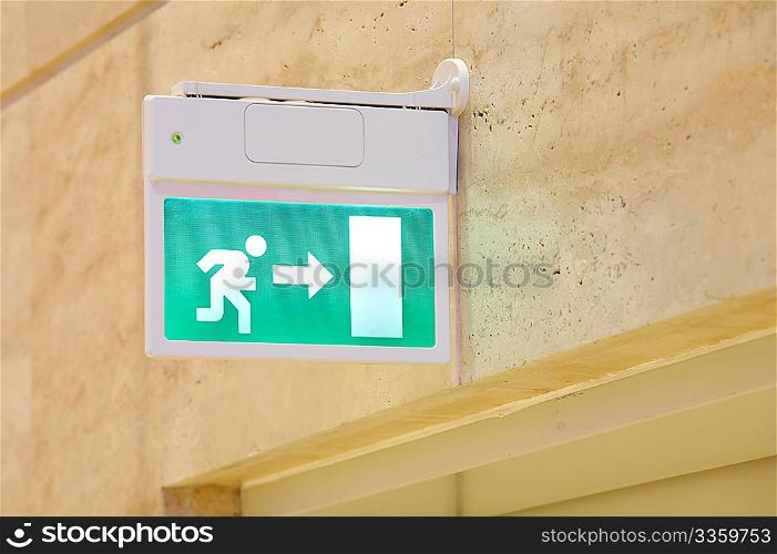 The green sign of an exit with the running person
