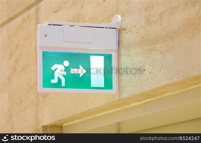 The green sign of an exit with the running person. Sign Exit