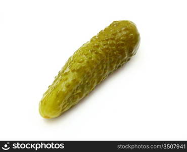 The green tasty pickle lies on a white background