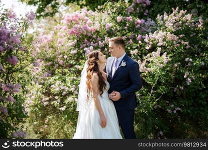 the groom and the bride are walking in the forest on a bright day