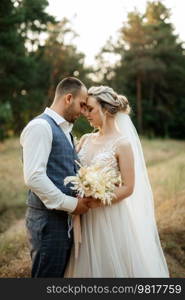 the groom and the bride are walking in the forest on a bright day