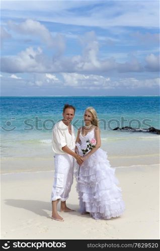 The groom and the bride on the tropical beach.