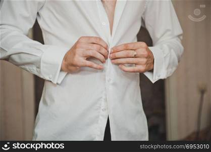 The groom dresses white a shirt.. The young man dresses a shirt 1876.