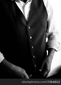 The groom in a suit hugs the bride in a wedding dress close up. The groom in a suit hugs the bride in a wedding dress