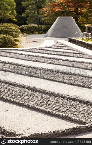 The grounds at the the Silver Pavilion complex, or Ginkakuji, in Jyoto are highlighted by a Zen garden of carefully raked sand coupled with a perfect cone-shaped mountain of sand.