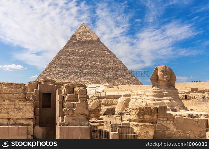 The Grreat Sphinx, ruins of the temple of Giza and the Puramid of Kafre, Cairo, Egypt.. The Grreat Sphinx, ruins of the temple of Giza and the Puramid of Kafre, Cairo, Egypt