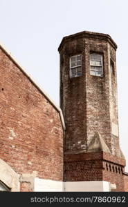 The guard tower over the main gate entrance to the Seodaemun Prison in Seoul, Korea stands over the main prison yard.