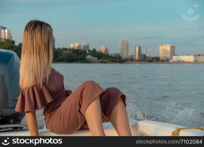 The guy jumps into the water from the boat. A beautiful girl is watching him. The guy jumps into the water from the boat. A beautiful girl is watching him.