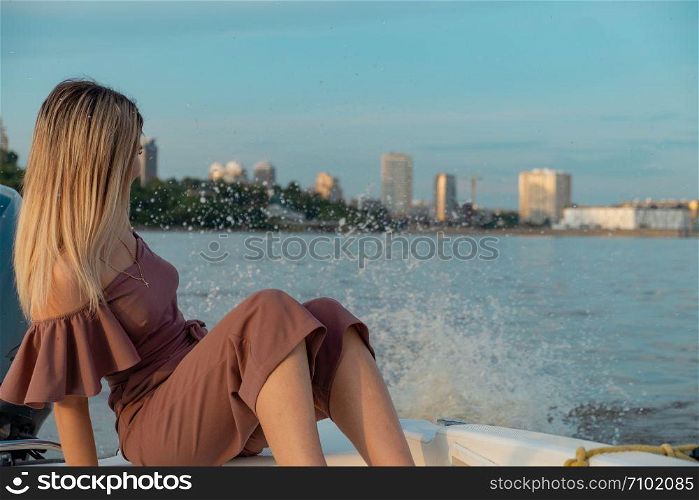 The guy jumps into the water from the boat. A beautiful girl is watching him. The guy jumps into the water from the boat. A beautiful girl is watching him.