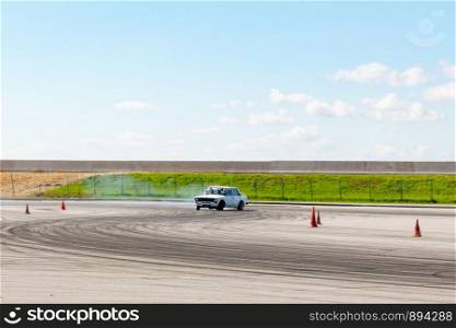 The guy on the car Lada white trains to drift.. Khabarovsk, Russia - Jul 19, 2019: The guy on the car Lada white trains to drift.