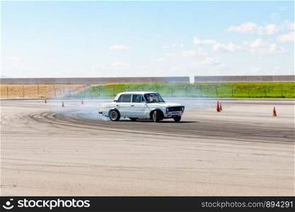 The guy on the car Lada white trains to drift.. Khabarovsk, Russia - Jul 19, 2019: The guy on the car Lada white trains to drift.