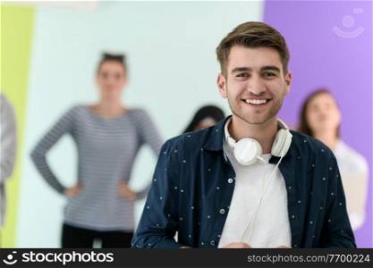 the guy with the beautiful smile in the blue attractive shirt i use my cell phone and headphones
