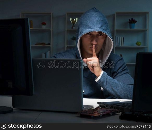 The hacker hacking computer at night. Hacker hacking computer at night