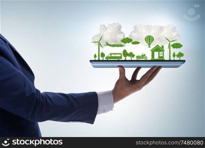 The hand holding tablet with mini ecosystem and clean energy. Hand holding tablet with mini ecosystem and clean energy