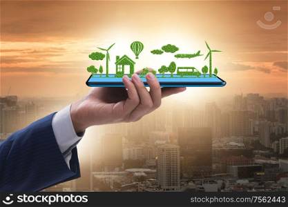 The hand holding tablet with mini ecosystem and clean energy. Hand holding tablet with mini ecosystem and clean energy
