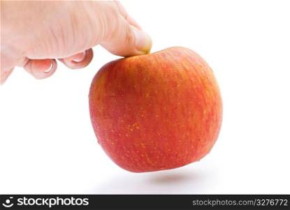 The hand is taking the apple away. Isolated with white background.