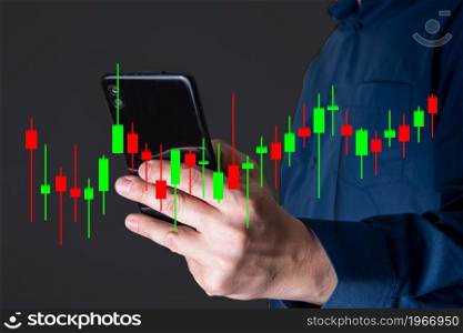 The hand of a businessman or trader shows a growing virtual hologram of stocks on a smartphone, planning and strategy, stock market. Business growth, the concept of progress or success. invest in trading.. The hand of a businessman or trader shows a growing virtual hologram of stocks on a smartphone.