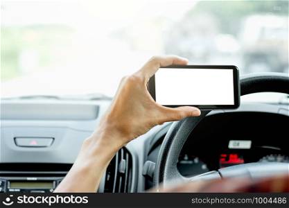 The hand of men are using smartphones in cars.