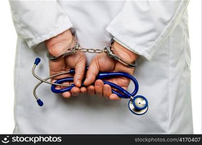 the hands of a doctor with a stethoscope and handcuffs