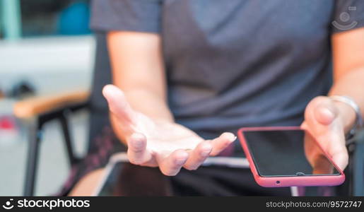 The hands of a woman holding a phone Suitable for making infographics.