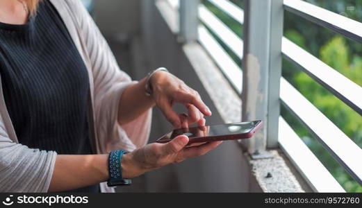 The hands of a woman holding a phone Suitable for making infographics.