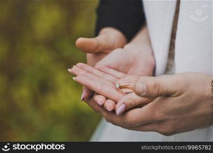 The hands of the newlyweds and wedding rings.. Wedding rings in the hands of the newlyweds 2487.