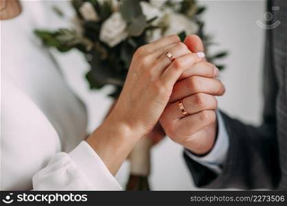 The hands of the newlyweds gently touch each other.. Tender embrace of the newlyweds on a summer day 3826.
