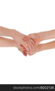 The hands of two young girls holding together in a closeup imageisolated for white background.