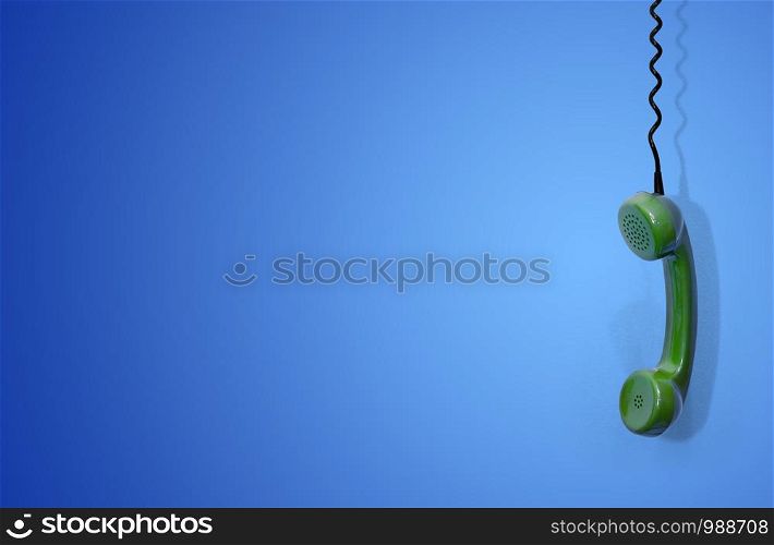 The handset of an retro analog telephone hangs on a wire on a blue background. The handset of an old analog telephone hangs on a wire on a blue background
