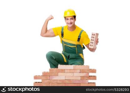 The handsome construction worker building brick wall