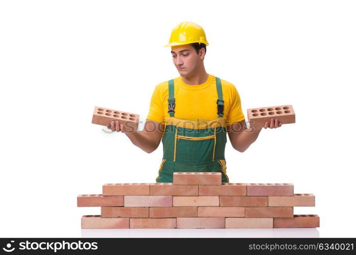 The handsome construction worker building brick wall