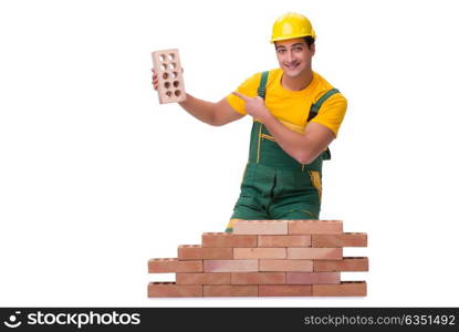 The handsome construction worker building brick wall