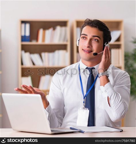 The handsome customer service clerk with headset. Handsome customer service clerk with headset