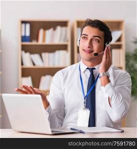 The handsome customer service clerk with headset. Handsome customer service clerk with headset