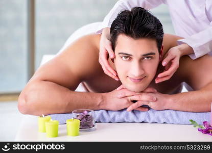 The handsome man in spa massage concept. Handsome man in spa massage concept