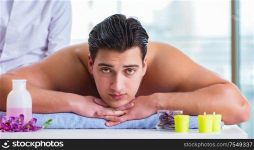 The handsome man in spa massage concept. Handsome man in spa massage concept