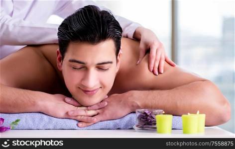 The handsome man in spa massage concept. Handsome man in spa massage concept
