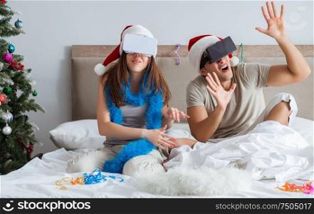 The happy couple celebrating christmas holiday in bed. Happy couple celebrating christmas holiday in bed