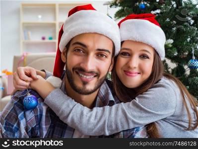The happy couple hugging during christmas. Happy couple hugging during christmas