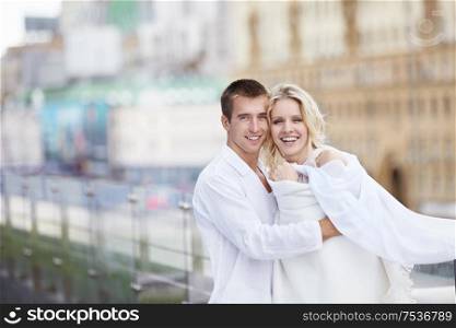 The happy couple in white on the roof
