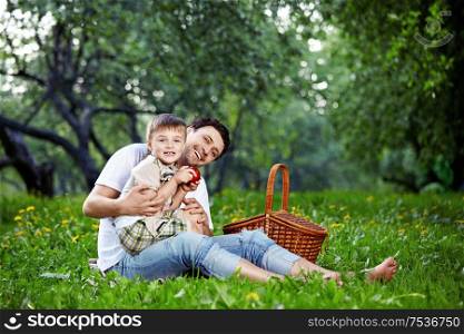 The happy daddy with the child on picnic