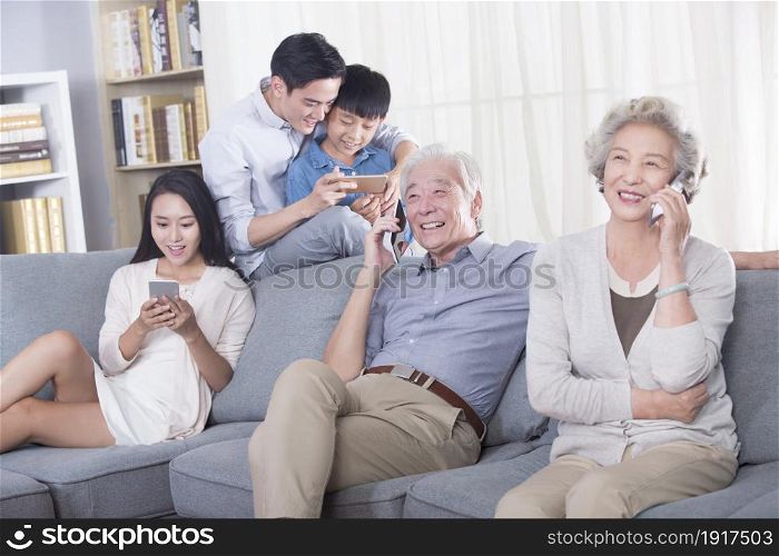 The happy family using their phones