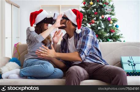 The happy family using virtual reality vr glasses during christmas. Happy family using virtual reality VR glasses during christmas
