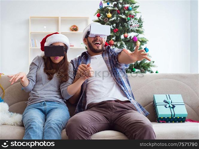 The happy family using virtual reality vr glasses during christmas. Happy family using virtual reality VR glasses during christmas