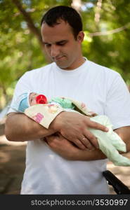 The happy father with the small son on walk in park