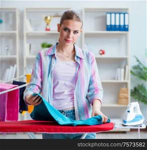 The happy housewife doing ironing at home. Happy housewife doing ironing at home