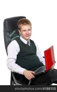 The happy schoolboy in office armchair, with the laptop