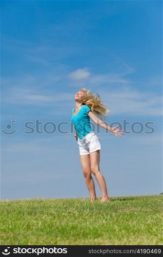 The happy young woman in the field