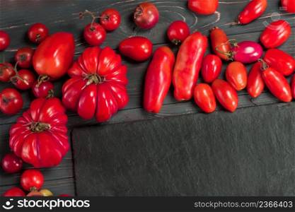 The harvest of mix tomatoes. Different colorful tomatoes. Tomatoes are different varieties. Mix tomatoes background. Different sorts of tomatoes. Organic green, red, yellow, orange tomatoes