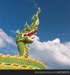 The head of asian dragon on the cloudy sky background